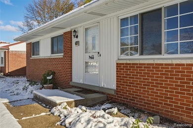 Entrance to property featuring brick siding