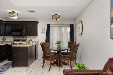 Dining space with light tile patterned floors, baseboards, and visible vents