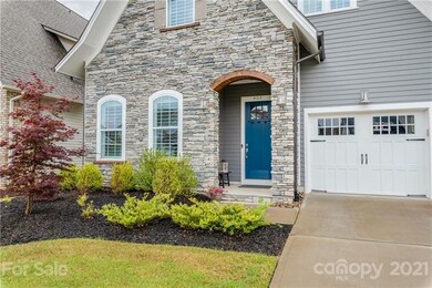 Beautiful arched entry with inviting craftsmen fro