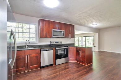 Kitchen featuring stainless steel appliances, a si