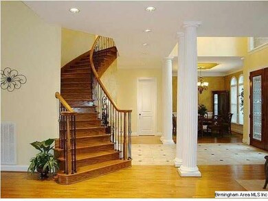 The 2-story foyer has custom doors, marble floor a
