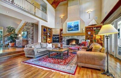 Huge great room with soaring beamed ceilings openi