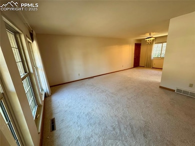 Unfurnished room featuring baseboards, carpet floo
