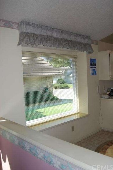 Pony wall and bay window in kitchen family eating 