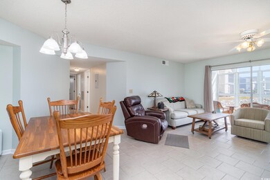 Dining room with ceiling fan with notable chandeli