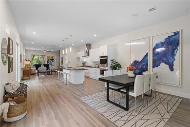 Dining area featuring baseboards, light wood-style floors, visible vents, and recessed lighting