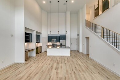 Kitchen with baseboards, light wood-style flooring