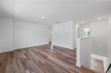 Spare room featuring wood finished floors, baseboards, and recessed lighting
