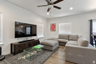 Living room featuring wood finished floors, recessed lighting, and ceiling fan