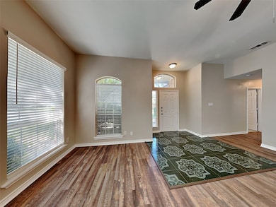 Entrance foyer featuring wood finished floors and ceiling fan