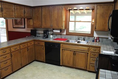 Kitchen window looks out onto rear deck and back y