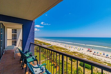 Balcony featuring a view of the beach and a water 