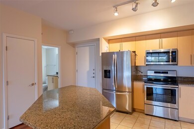 Kitchen with dark stone countertops, appliances w