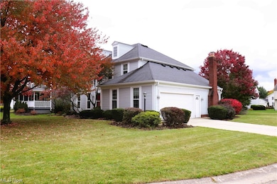 View of front of house featuring a garage and a front yard