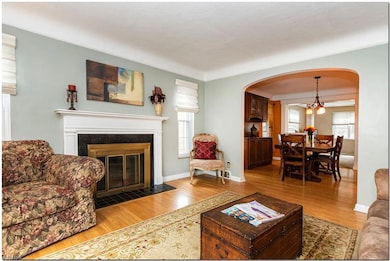 Living room with a fireplace and light hardwood floors