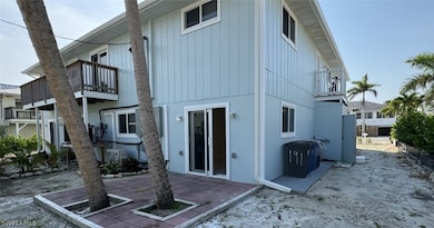 Back of property featuring a balcony and a patio