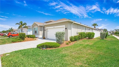 View of front of home with stucco siding, an attached garage, and driveway