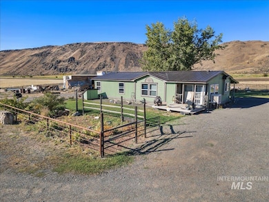 View of front of house with a mountain view and a metal roof
