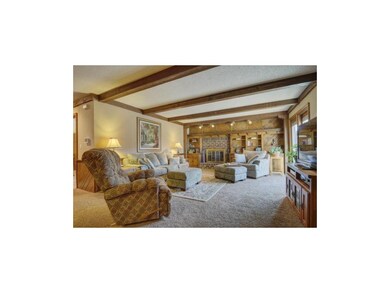 Family room features a brick fireplace flanked by 