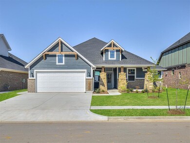 Craftsman-style house featuring concrete driveway, a front lawn, a shingled roof, and brick siding