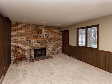 First Floor Family Room with Fireplace and Door to