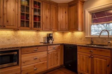 Tile backsplash accents the wooden...