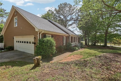 View of side of home with a shingled roof