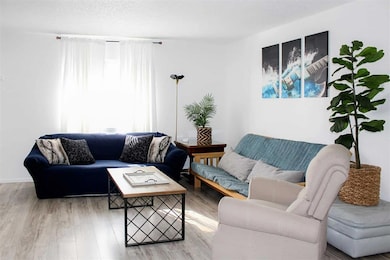 Living room with wood finished floors and a textured ceiling