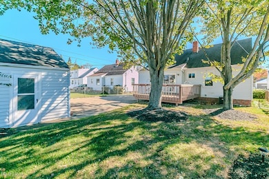View of yard with a wooden deck and an outdoor structure