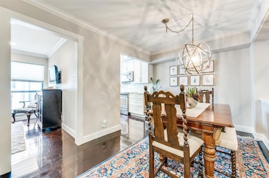 Dining room with crown molding, a chandelier, and 