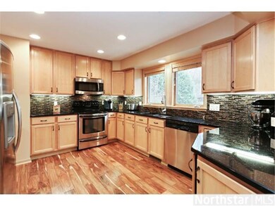 Updated kitchen with picturesque view of back pati