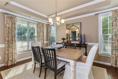 Lots of light in dining room with trey ceiling.