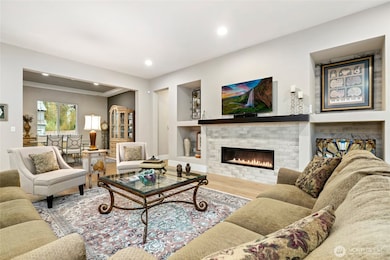 Great room with modern fireplace and custom built ins for audio/visual