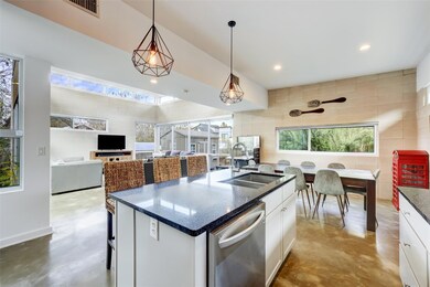 Kitchen featuring a sink, concrete flooring, stai