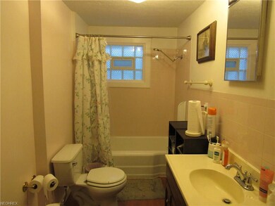 Neutral full bathroom with glass block window & ne