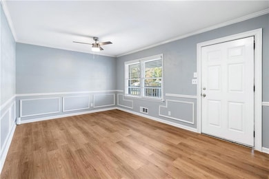 Foyer entrance with ceiling fan, ornamental moldin