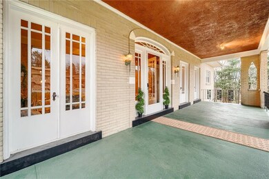 Beautiful large front porch featuring 3 sets of Fr