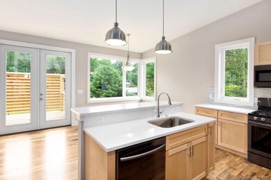 Quartz and Black Stainless Steel Kitchen