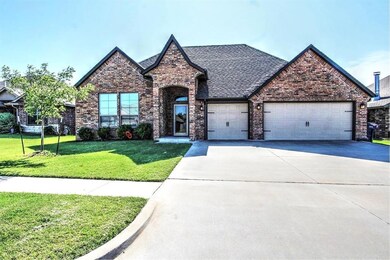 View of front facade with a garage and a front law