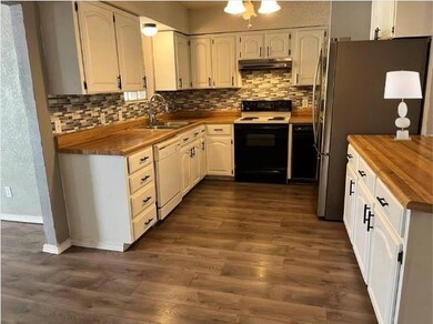 Kitchen UPDATED with glass backsplash, butcher block counters & luxury vinyl floors. Trash compactor, breakfast bar & large pantry. Open to Family Room.
