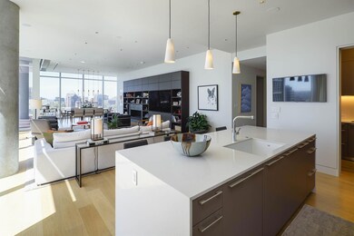 Kitchen featuring a center island with sink, light