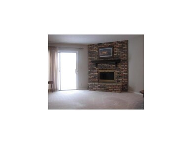 Living Room. Brick fireplace and sliders to expand