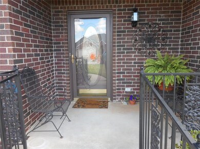 Front entry, covered porch, nice handrails to help you up the step