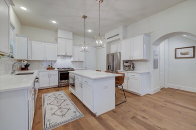 Crisp white cabinetry, gleaming quartz countertops