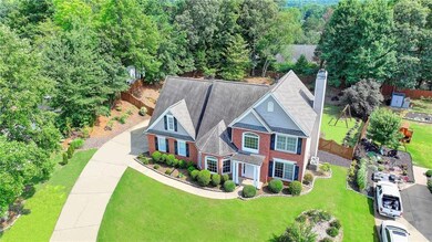 View of front of home with a chimney and brick siding