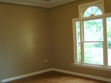 This room has beautiful window and hardwood floors