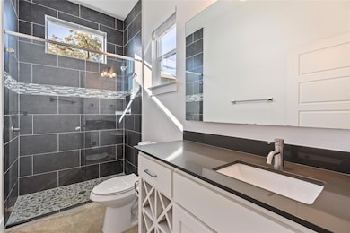 Full bathroom with vanity and a shower stall