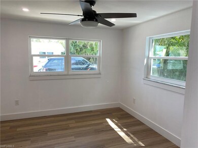 Empty room with dark hardwood / wood-style floors 