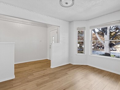 Light, bright and spacious dining room with bay of windows open to front of house