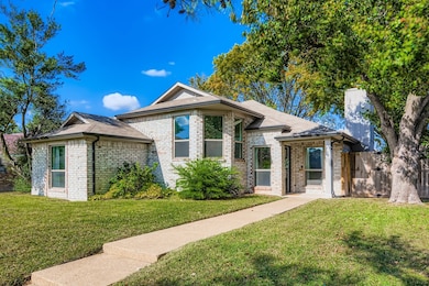 Ranch-style home featuring brick siding and a shingled roof